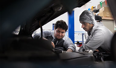 students repairing car image